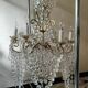 A pair of imposing, antique chandeliers with pendants.
