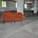 Pair of Mid-Century armchairs in black metal and orange fabric, VEB Sitzmöbelwerke, 1960s.