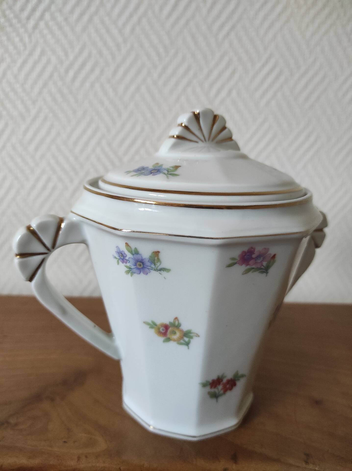 Antique porcelain sugar bowl with a decagonal base.