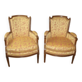 Pair of Louis XVI Bergères in walnut, late 18th century.