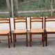 4 dining or kitchen chairs made of solid wood with rush seats.