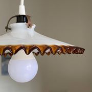 Old pendant light with a white opaline glass shade and a wavy border.