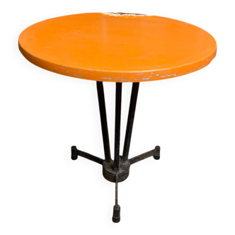 Vintage bistro table with black cast iron base and orange bakelite top, 1950s