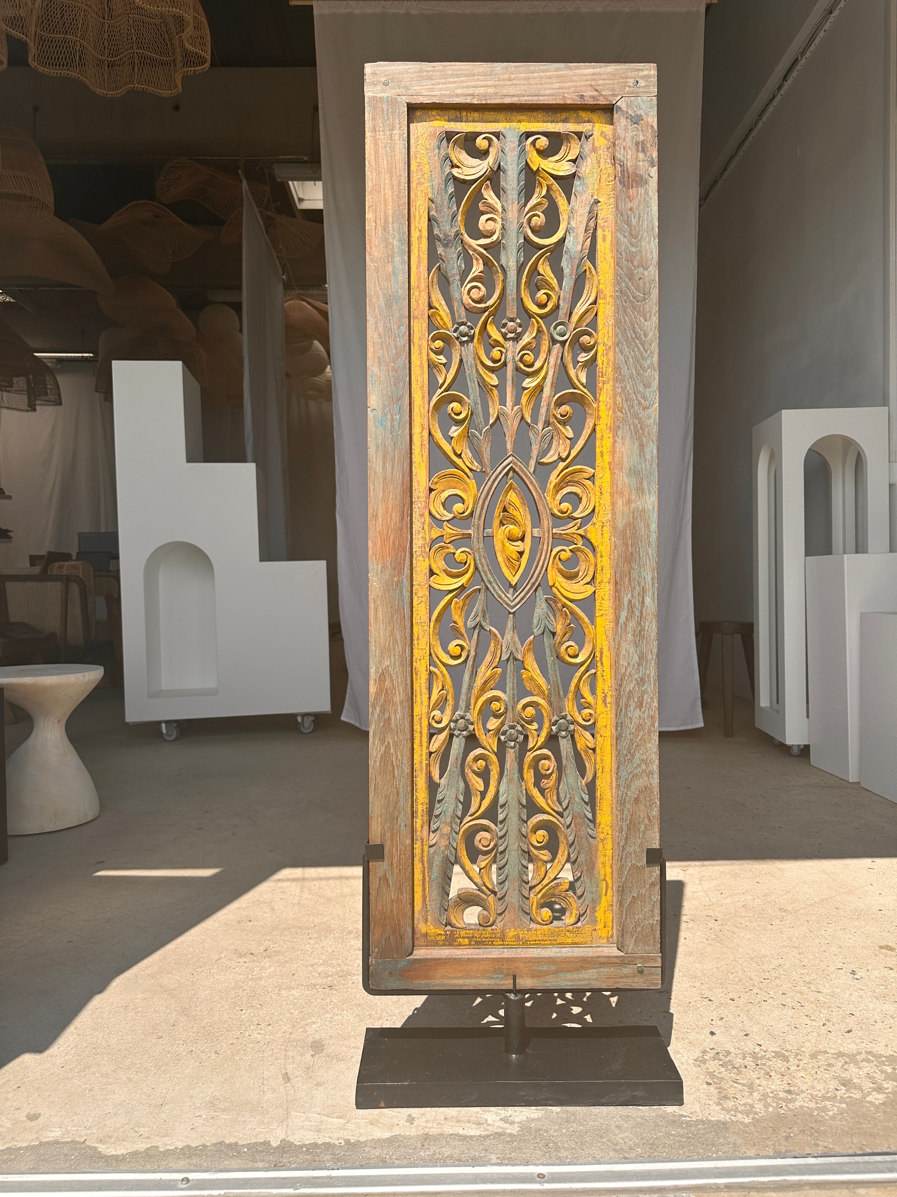 Rectangular Indonesian construction element with blue and yellow plant in carved wood