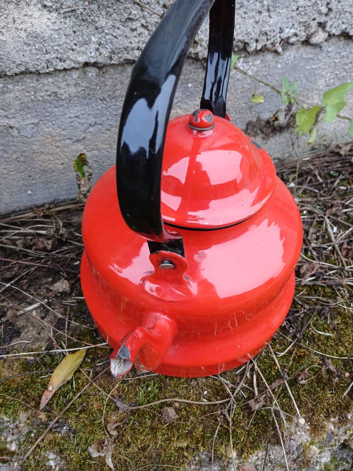 Antique teapot in red enamelled sheet metal