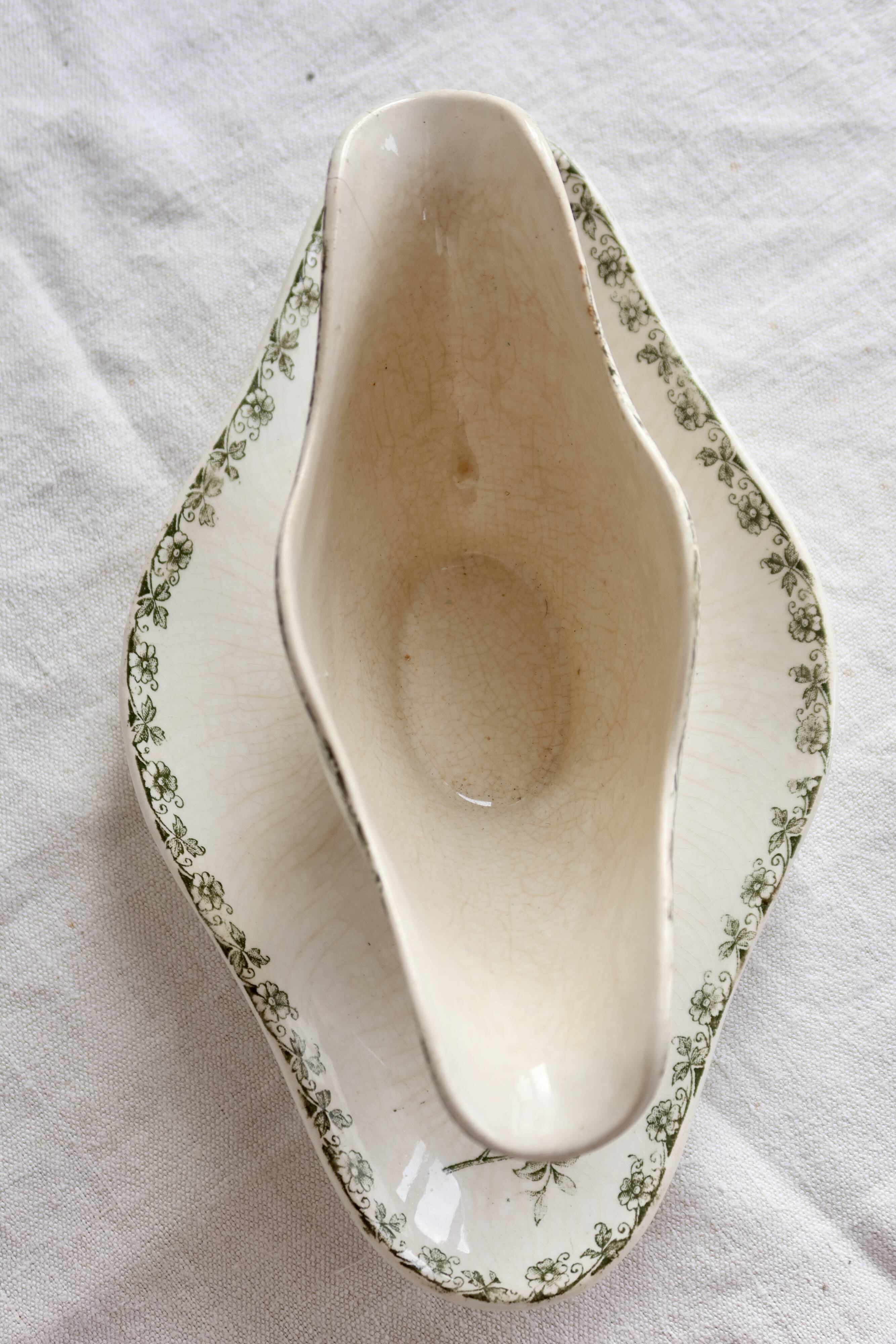 Antique sauce boat, ironstone, ivory with green floral and butterfly decoration.