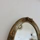 Oval wall mirror, golden floral pattern in stucco and wood, late 19th century