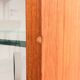 Teak display cabinet with black hairpin legs.