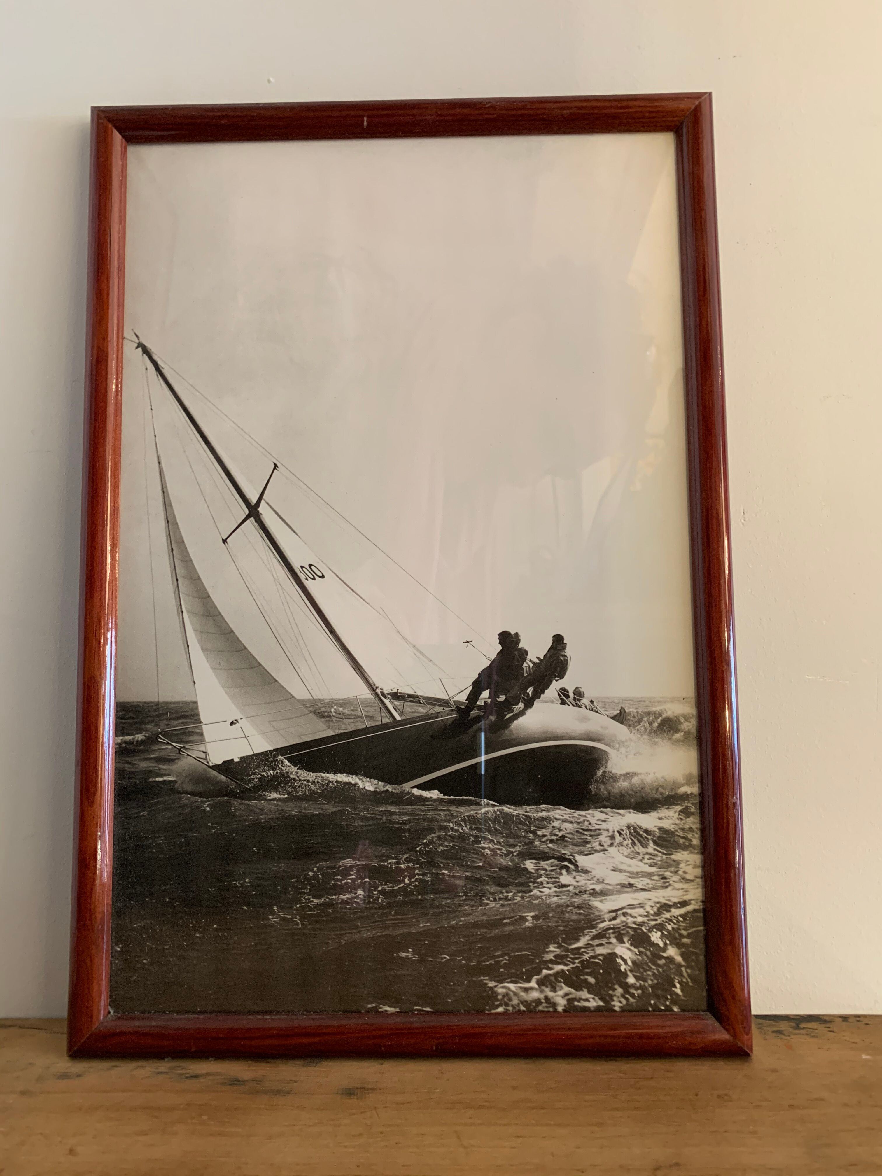 Three black and white-themed photographs sailboat boat with mahogany frame