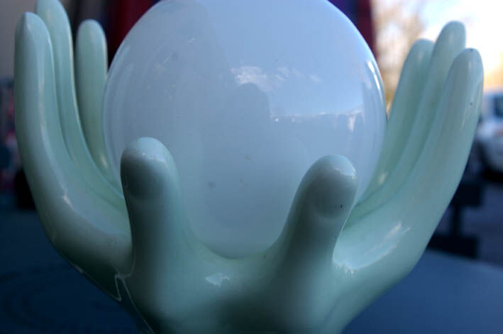 Pale green globe and hands ceramic lamp