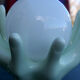 Pale green globe and hands ceramic lamp