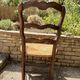 Antique Provençal armchair in wood with a straw seat.