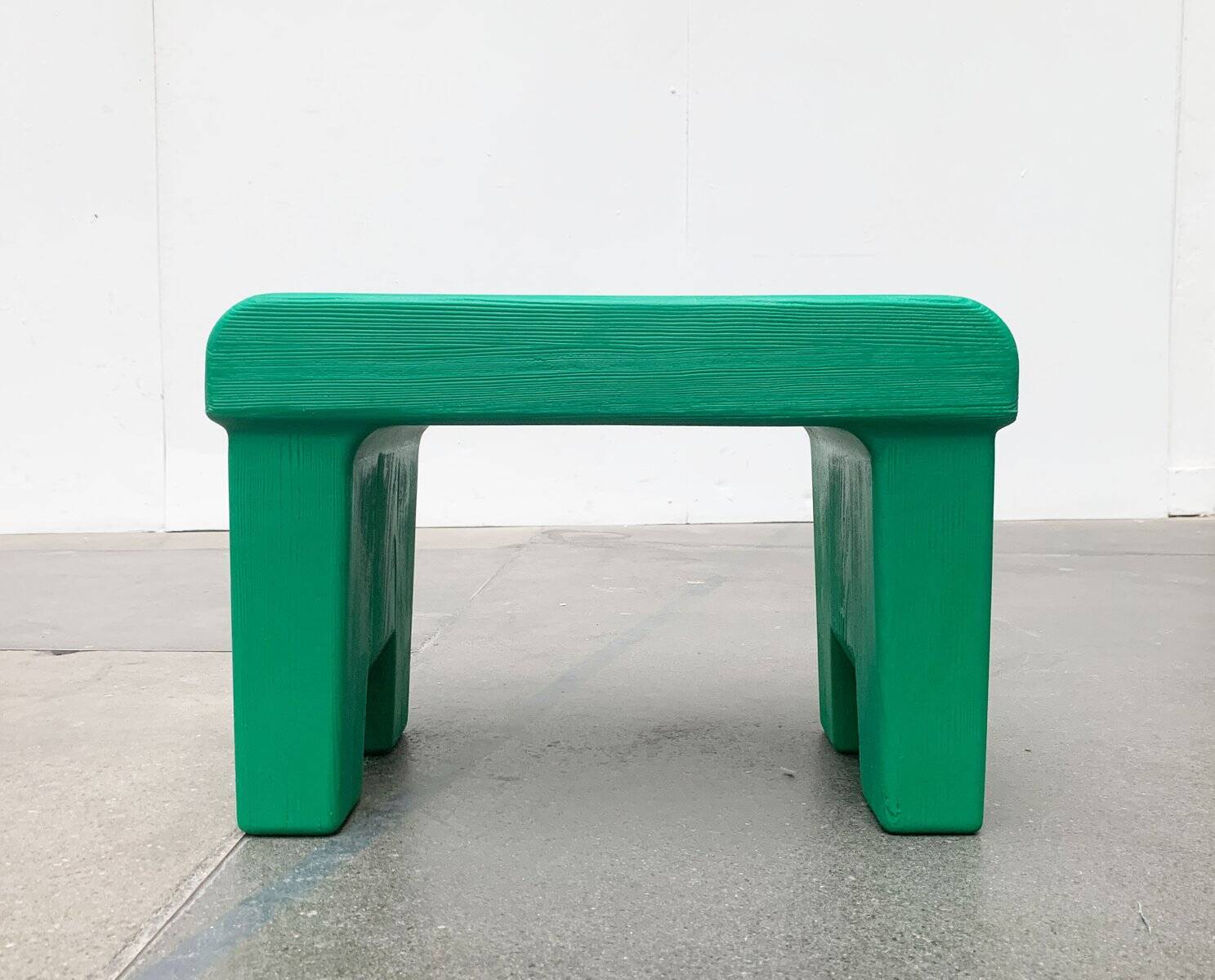 Postmodern plastic stool with a wood effect.