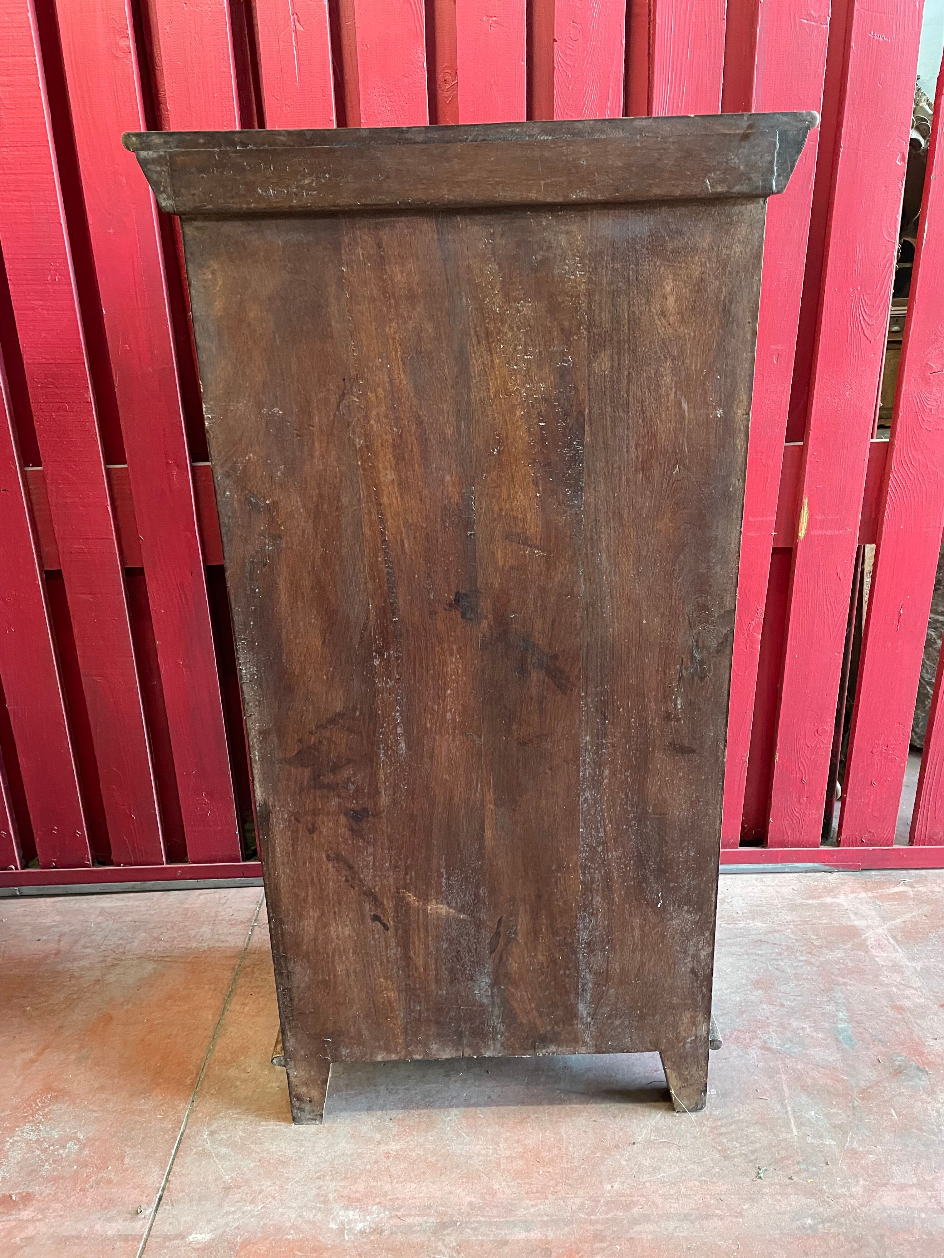 India. Bonnetière with a teak door finely carved by hand.