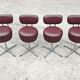 Set of 4 Mid Century Modern swivel chairs in tubular steel and leather.