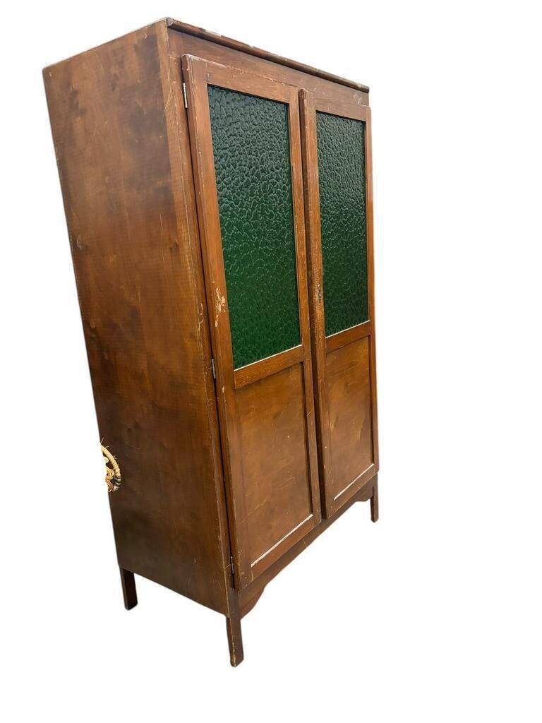 Vintage wooden display cabinet with green glass.