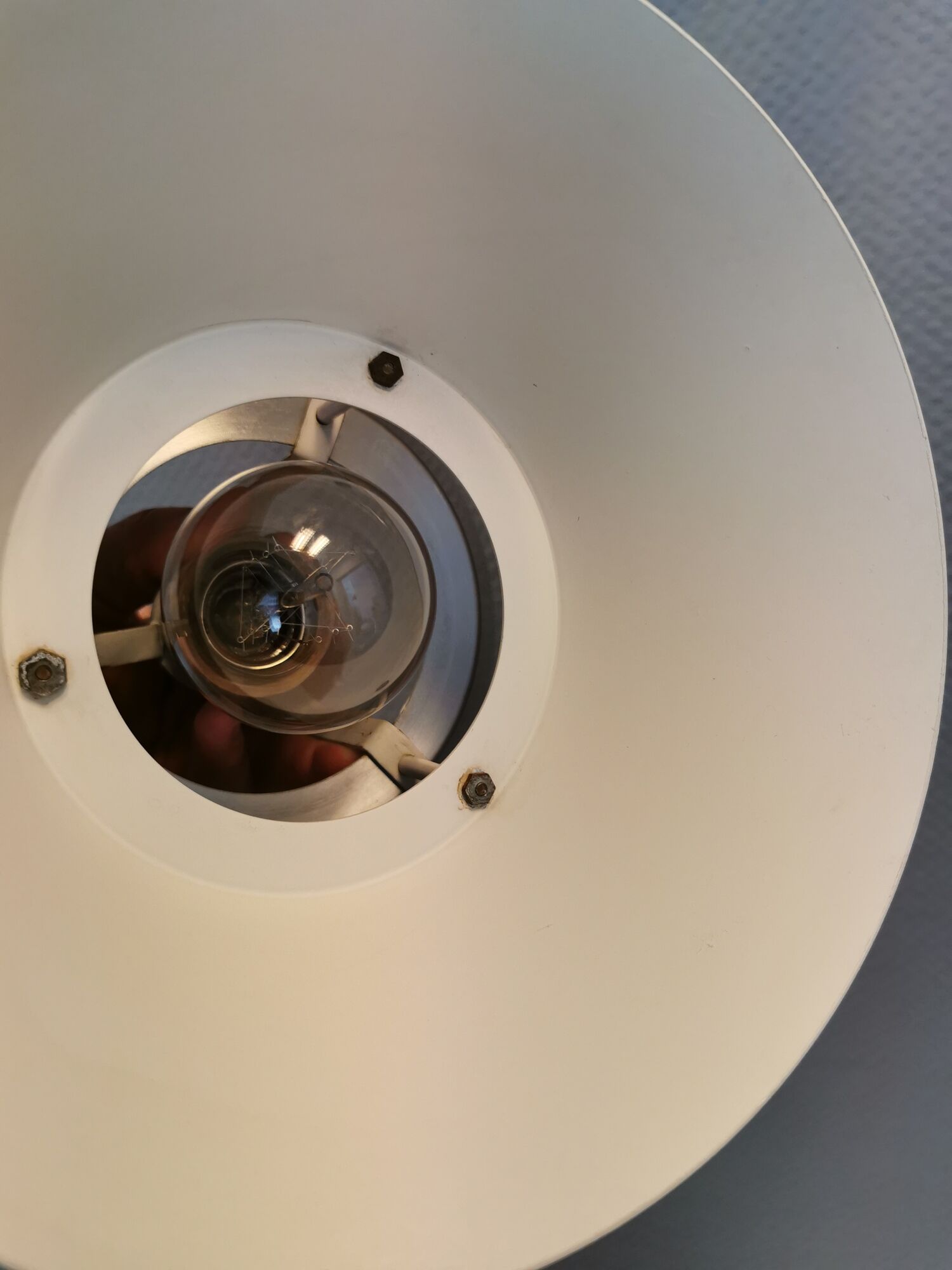 Hanging lamp,  of silver coloured aluminium with black "ring" and orange inner contrast lacquer.