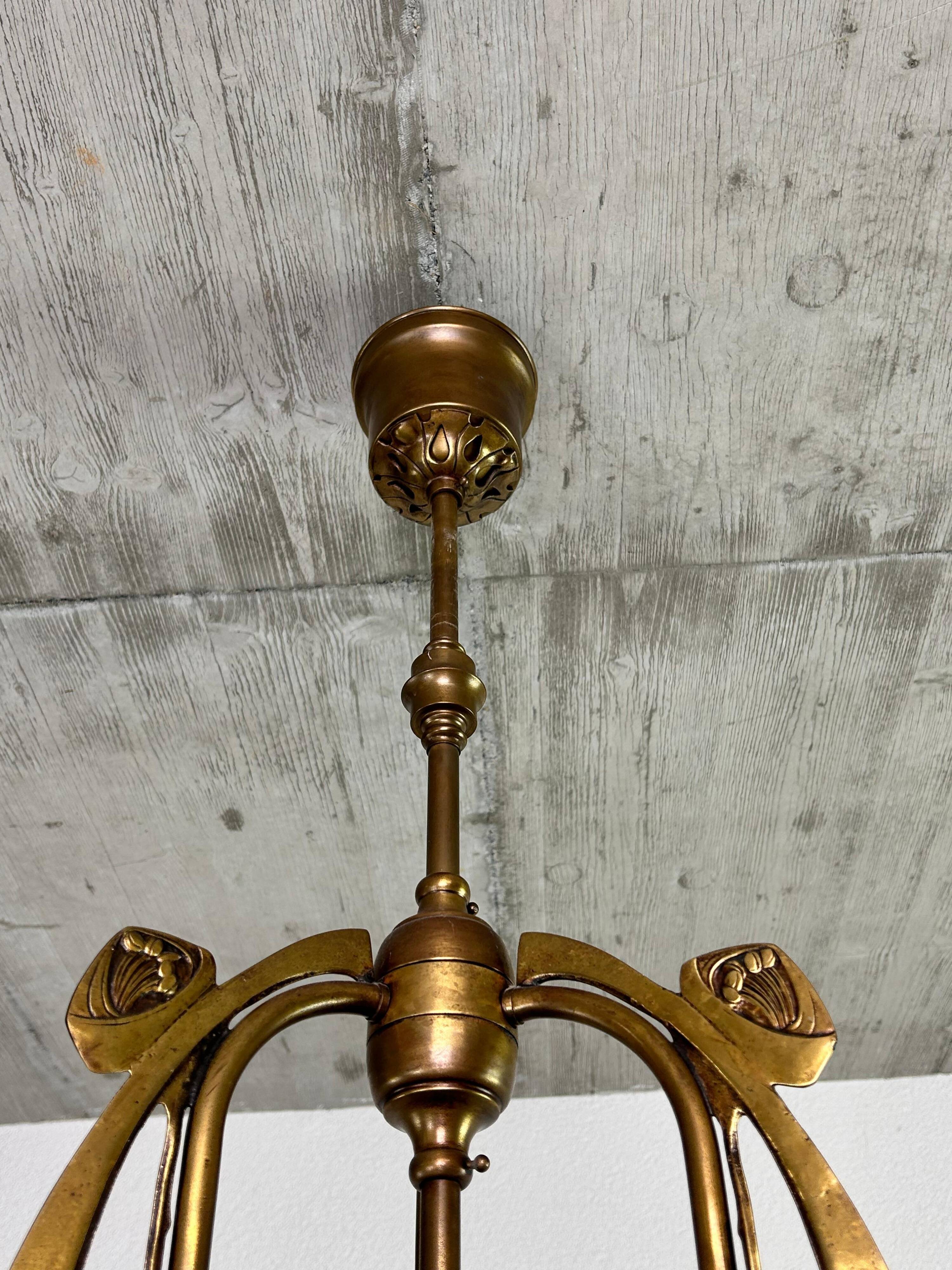 Art Nouveau chandelier with three arms and opalescent iridescent glass.