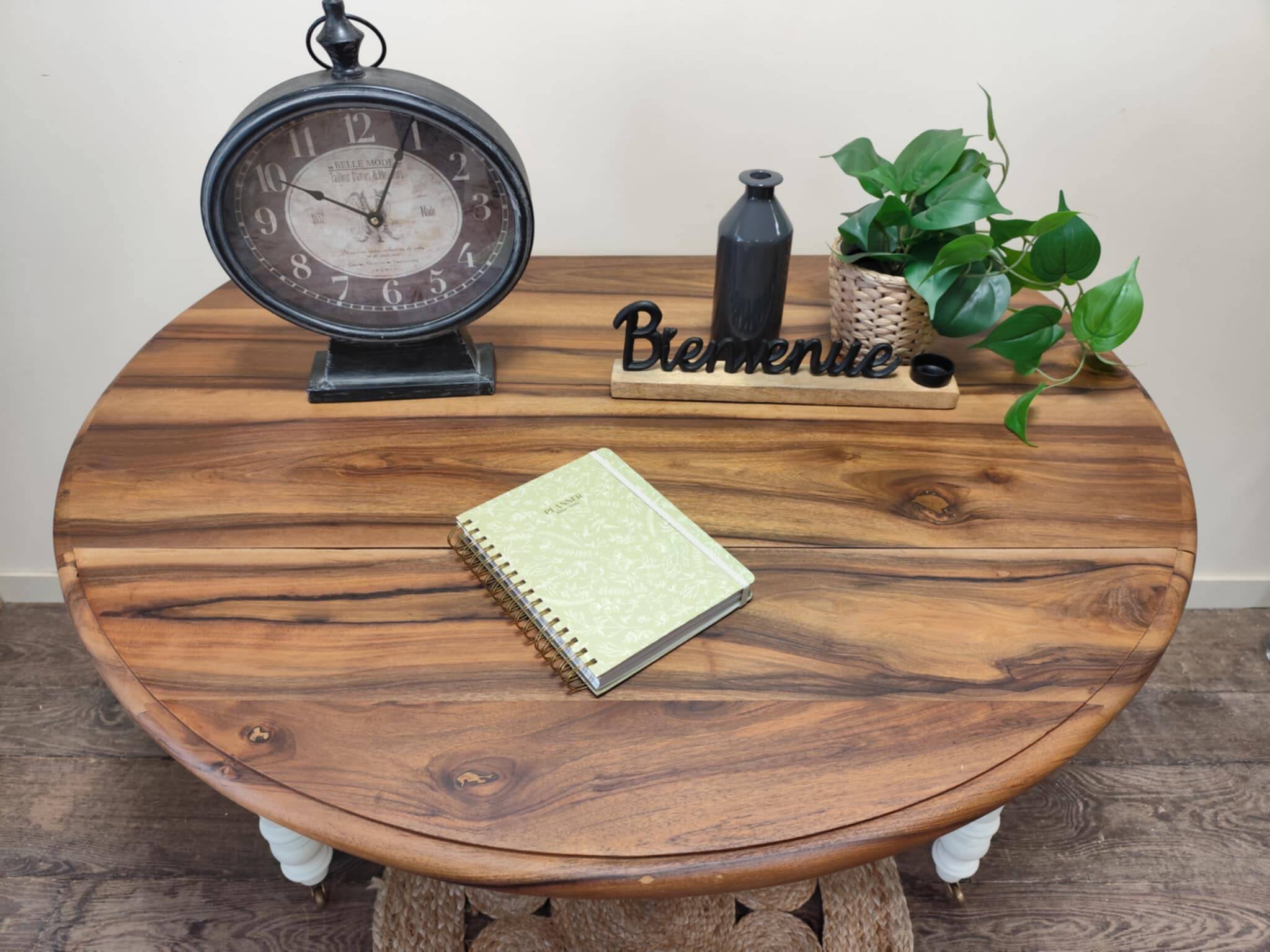 Round walnut table convertible into a console.