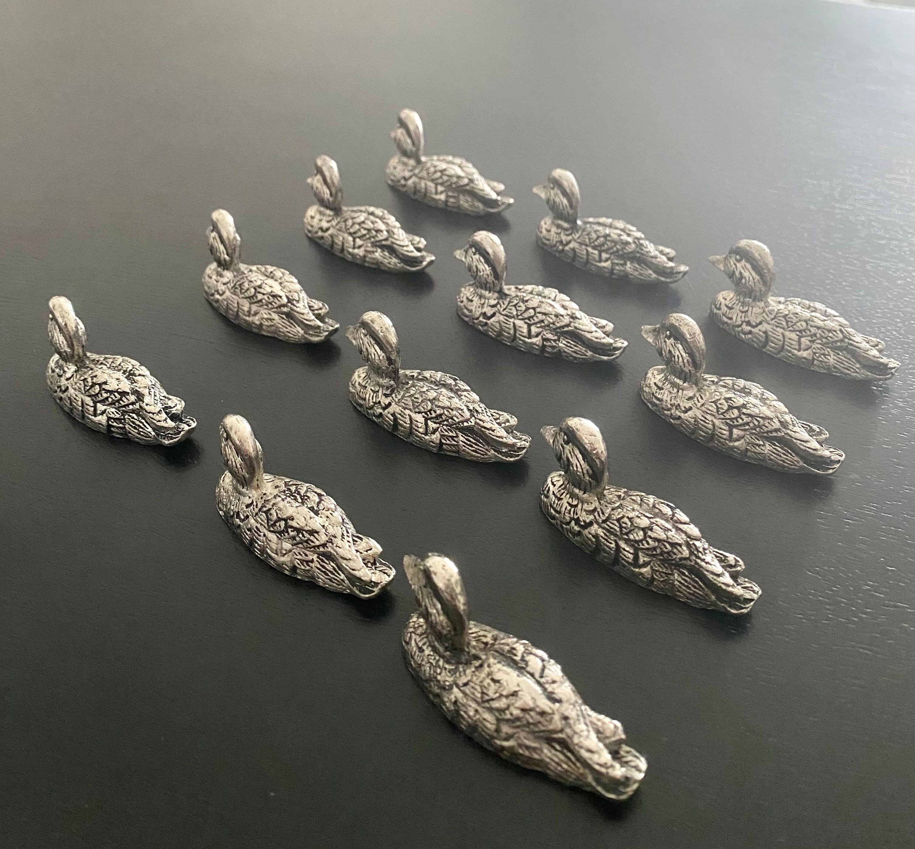 12 metal duck-shaped knife holders
