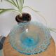 Plate on blue glass pedestal