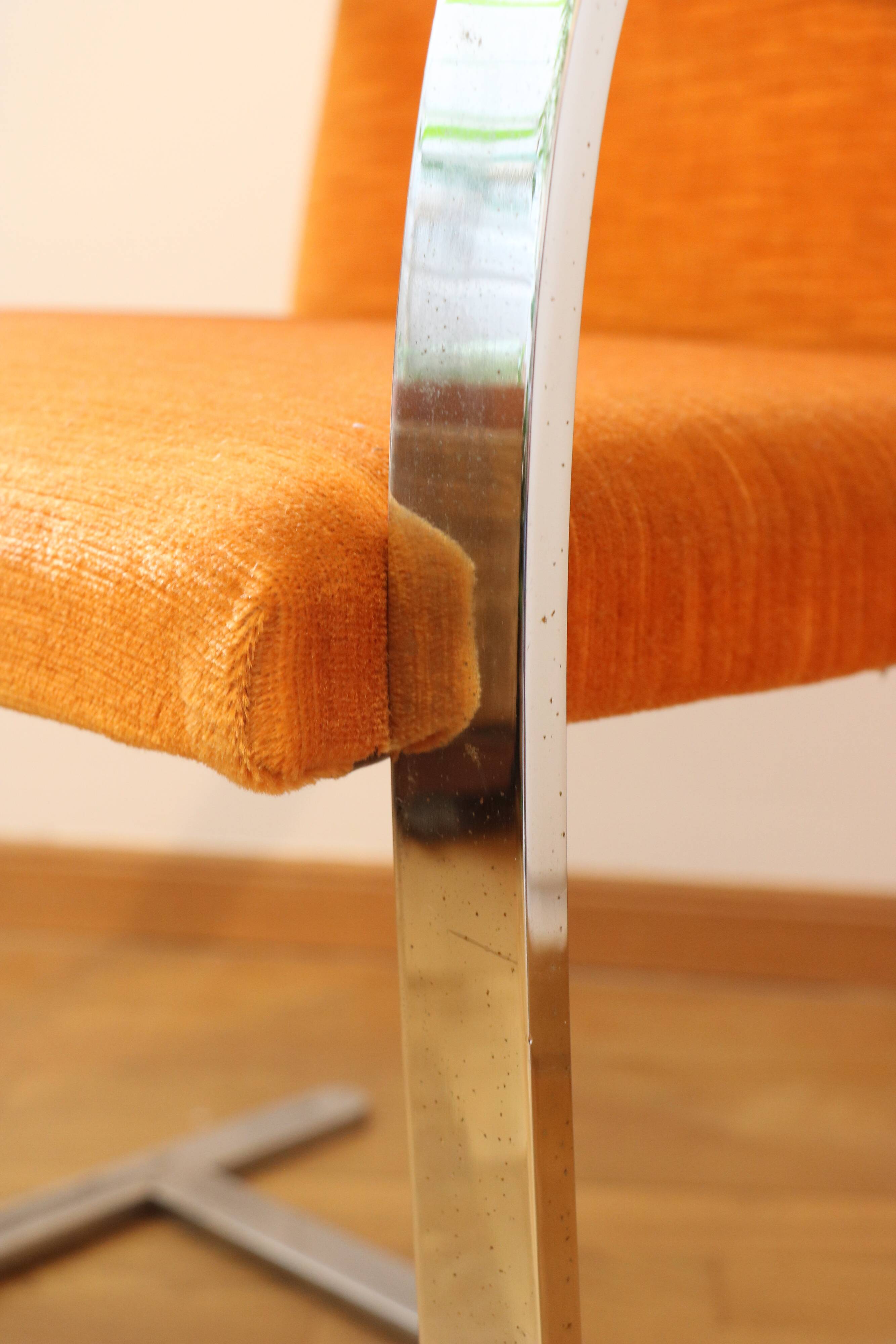 Chrome-plated metal and orange fabric armchair, 1970