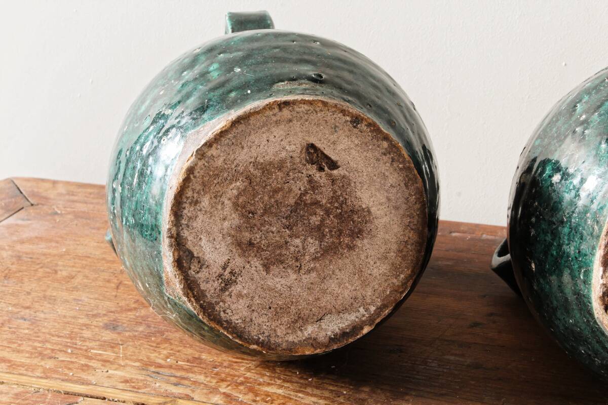 Set of two Chinese green glazed stoneware storage jars.