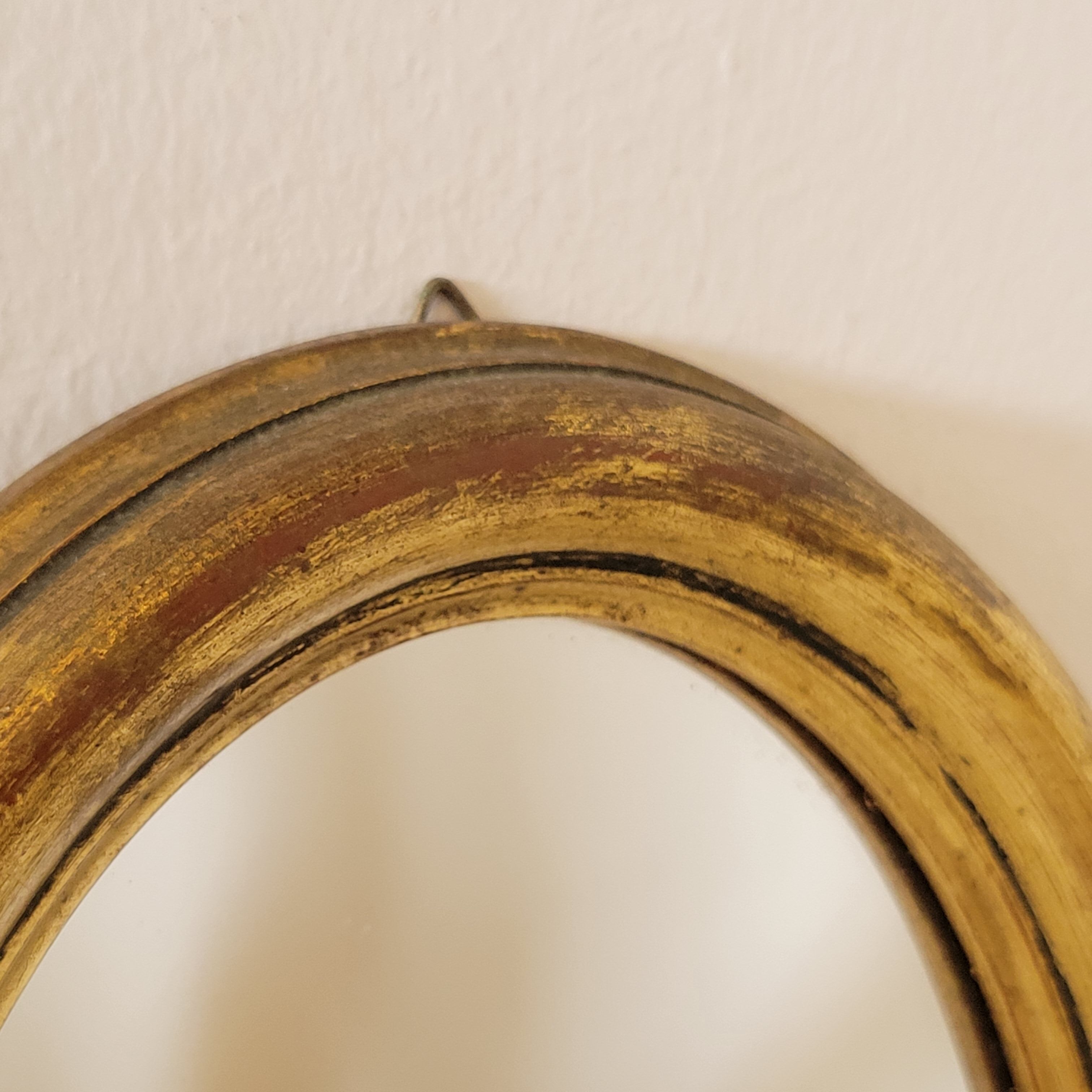 Old small oval mirror gilded wooden frame 22 X 17 X 2 cm.