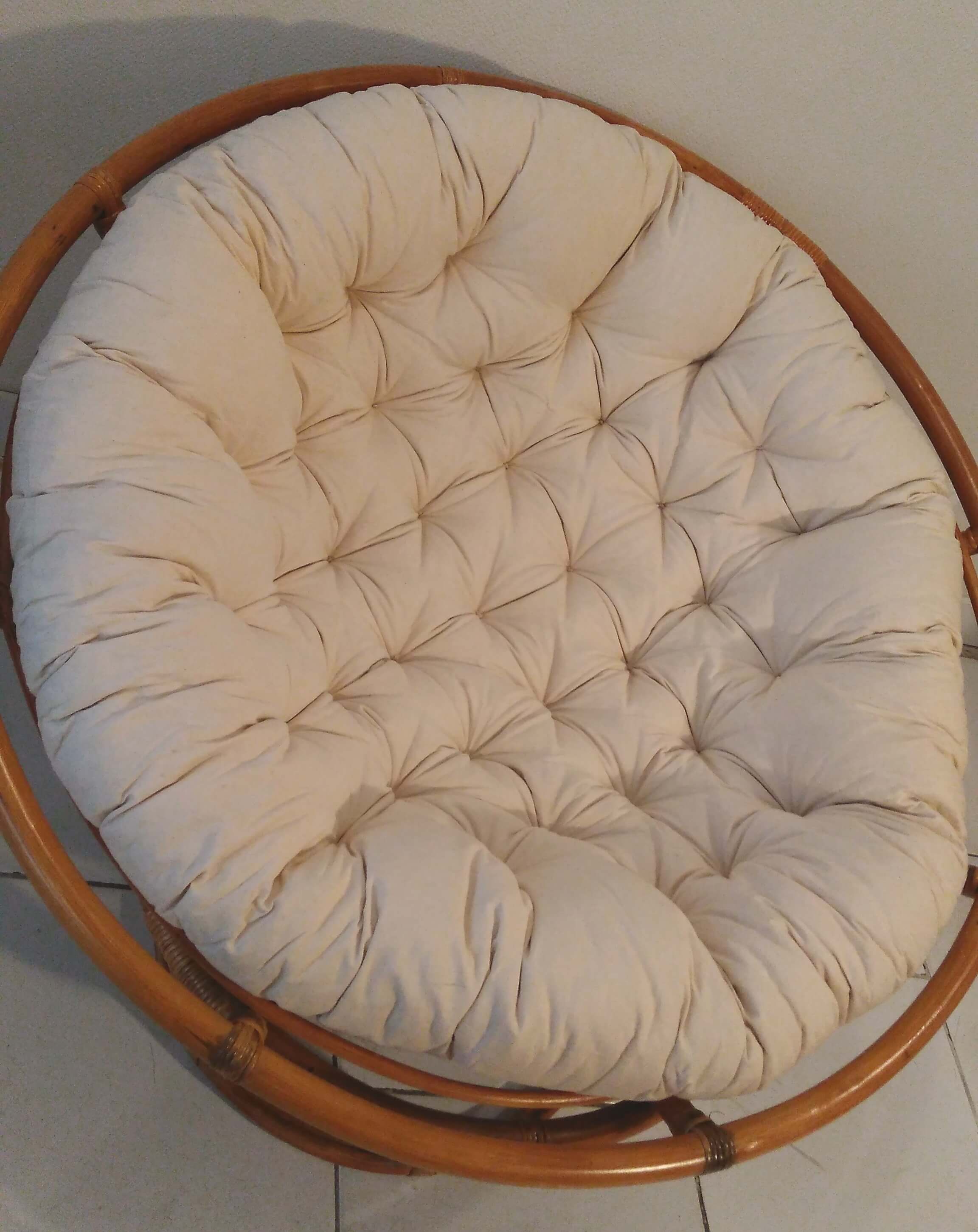 Rattan swivel chair and linen cushion