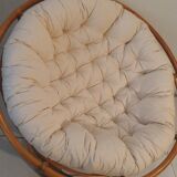 Rattan swivel chair and linen cushion