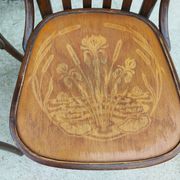4 bentwood bistro chairs with a pattern on the seat