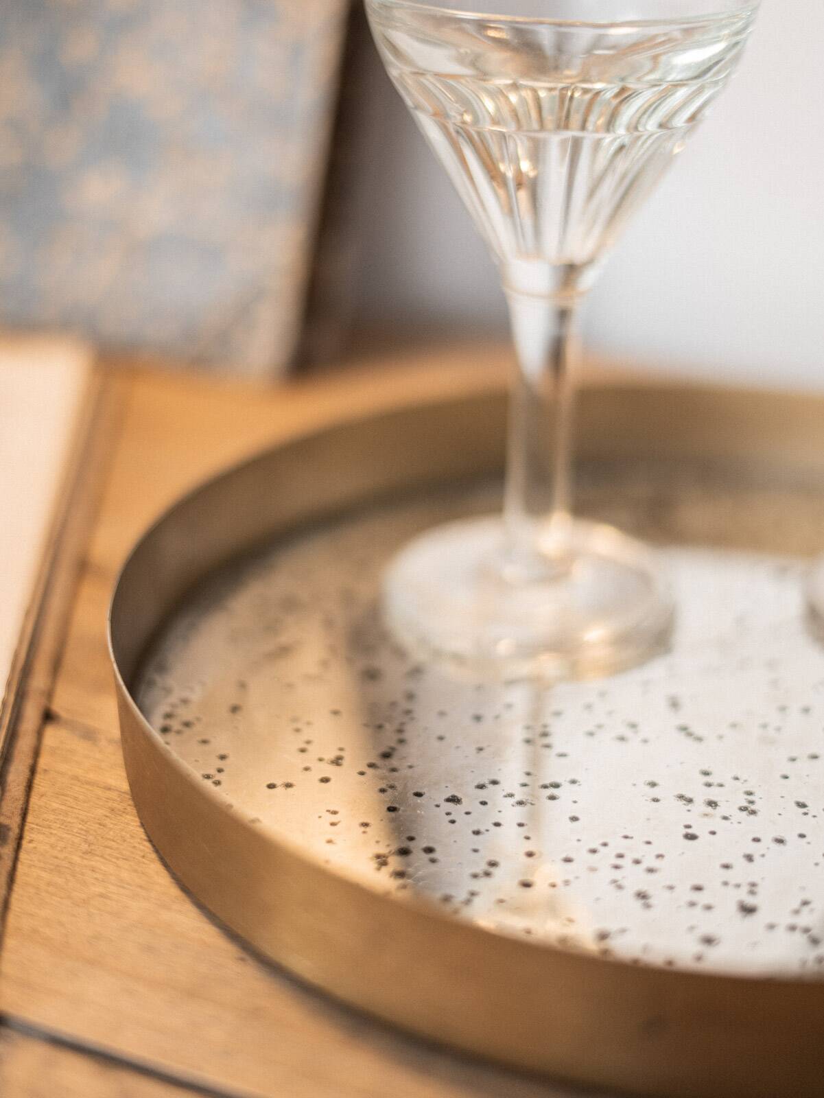 Patinated mirrored top and brass