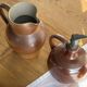 Ancient stoneware jug with a pewter spout.