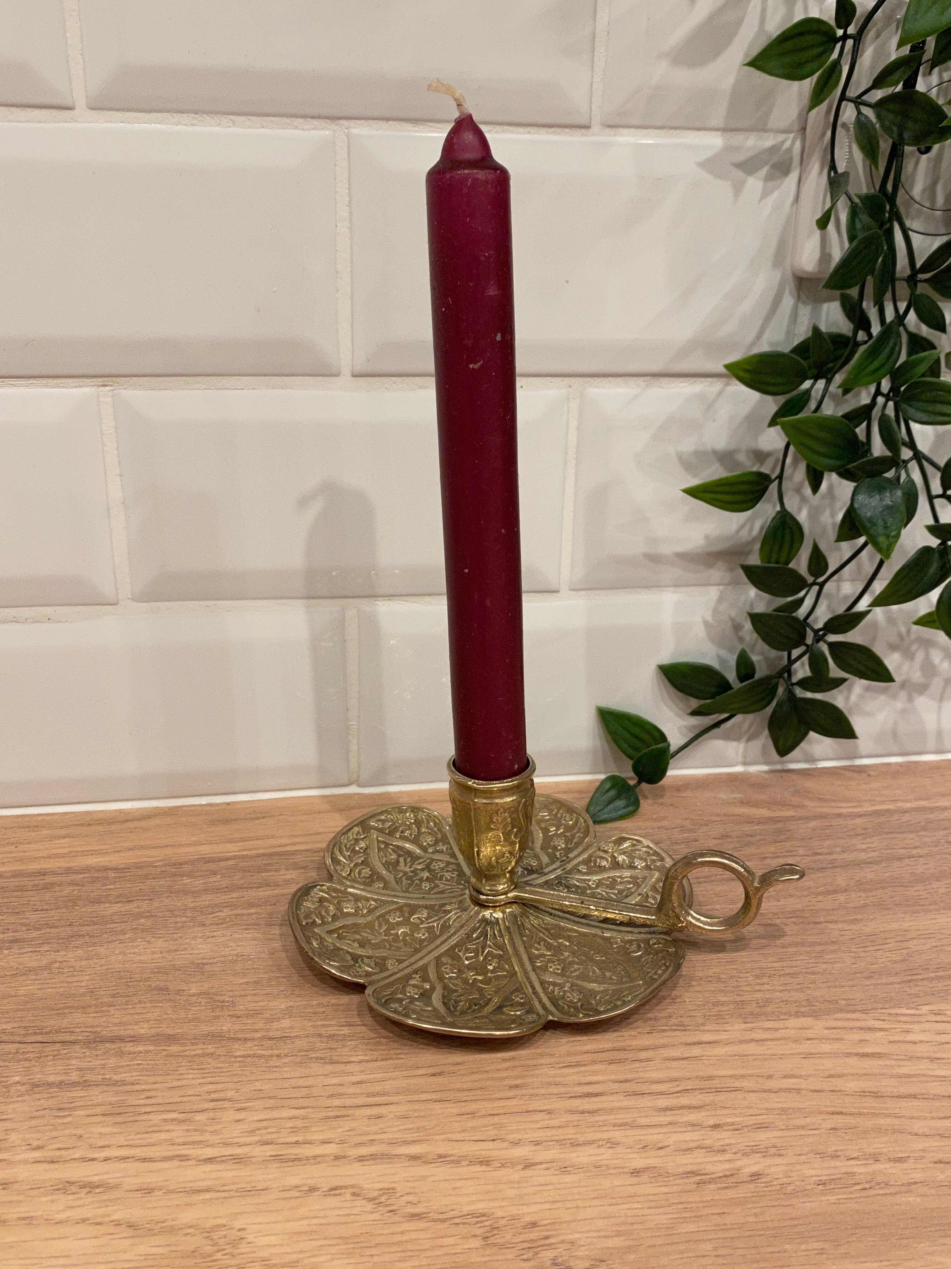Brass candle holder on frame