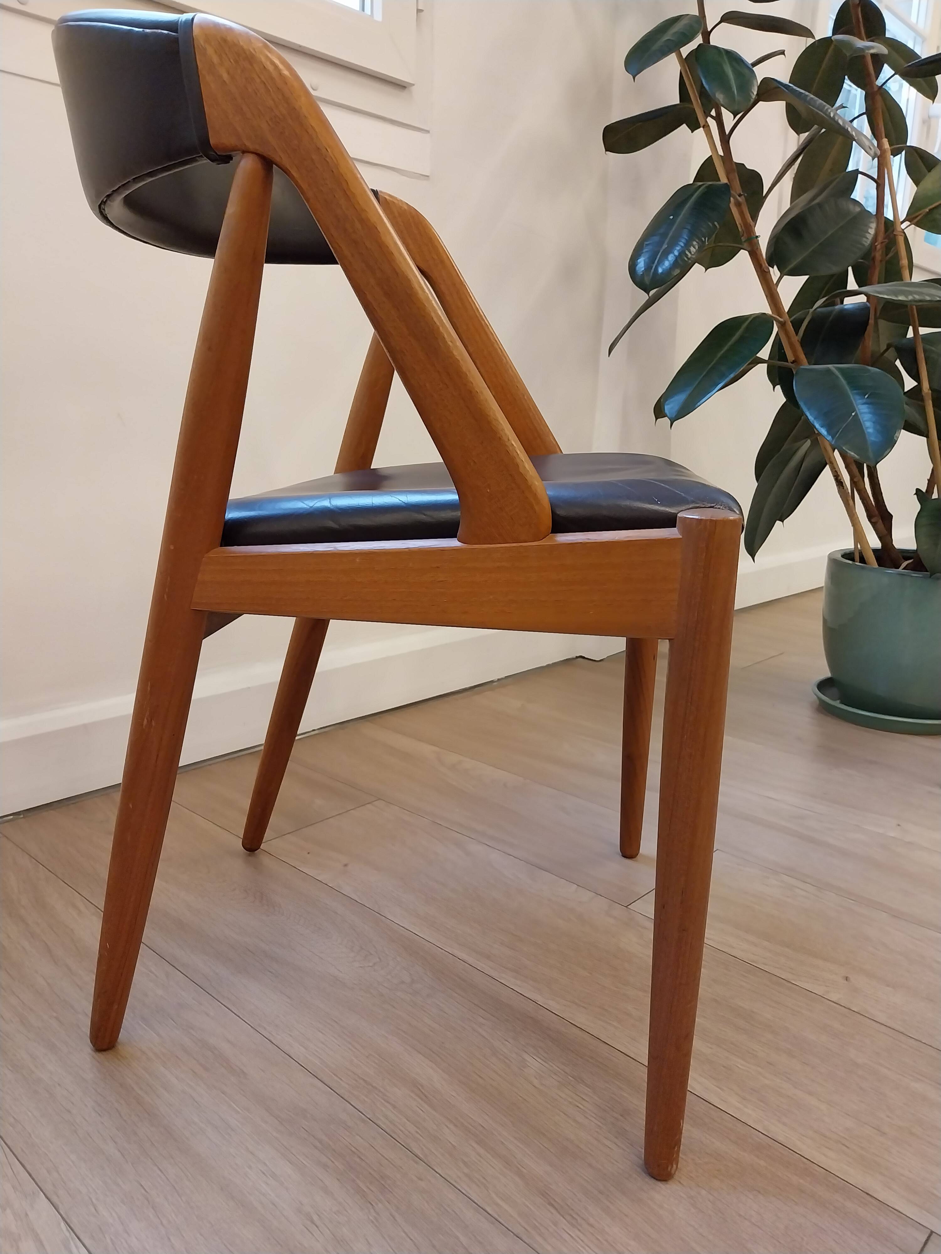 Set of 6 vintage Kai Kristiansen chairs in solid teak and black faux leather.