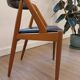 Set of 6 vintage Kai Kristiansen chairs in solid teak and black faux leather.
