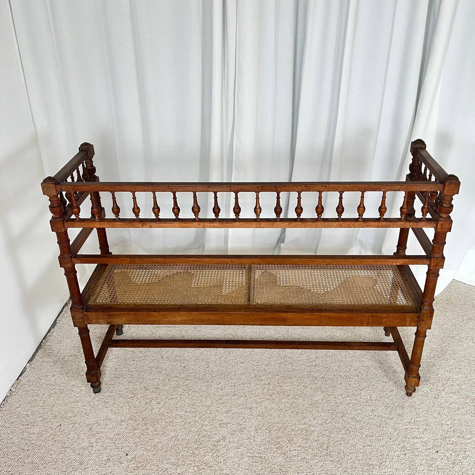 Antique banquette in Louis XIII style, turned wood with caning, late 19th to early 20th century.