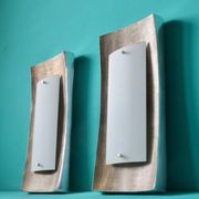 Pair of wall sconces in gold-plated alloy with bas-relief and opaline glass. Germany, 1980