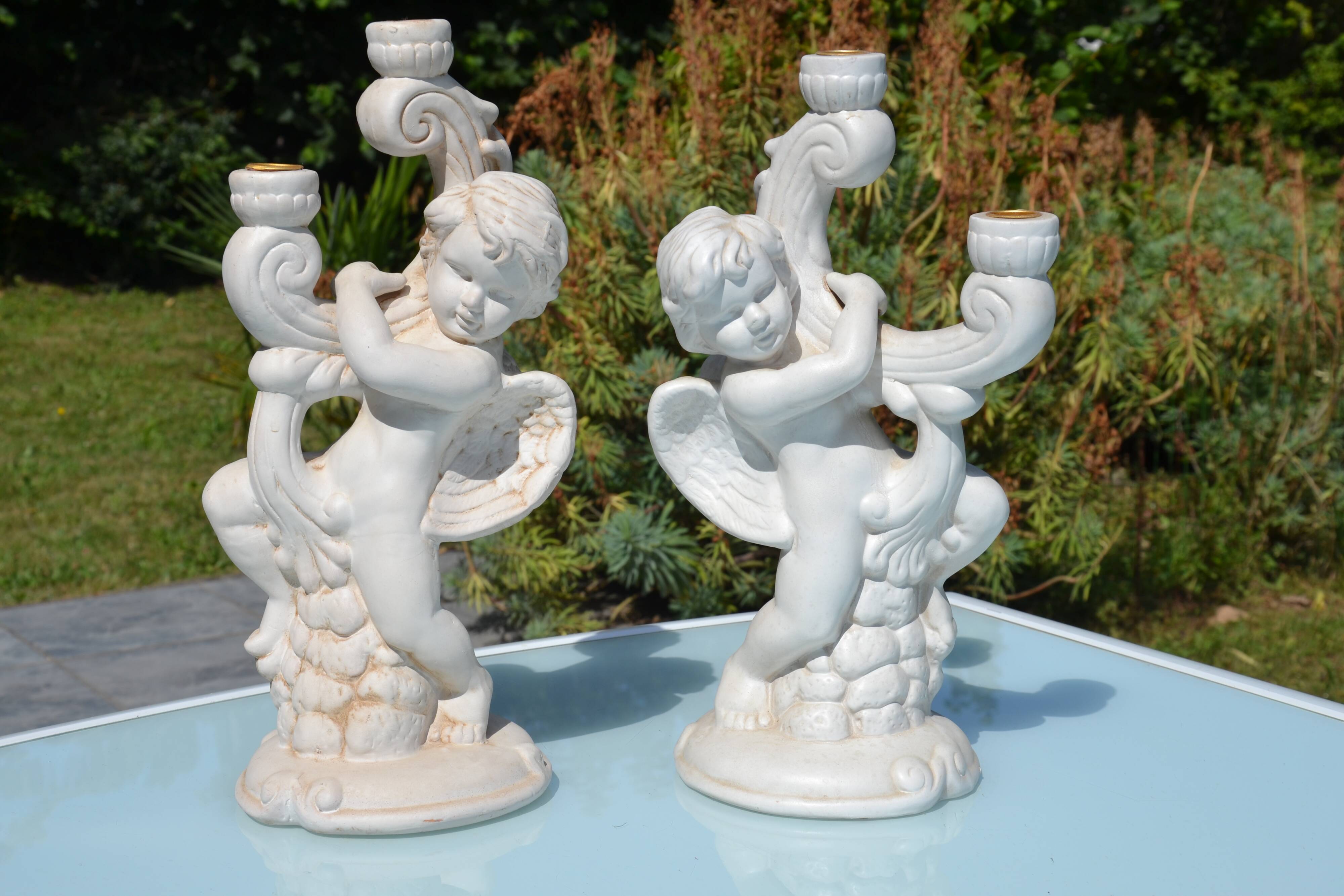 Pair of "cherub" candle holders in plaster