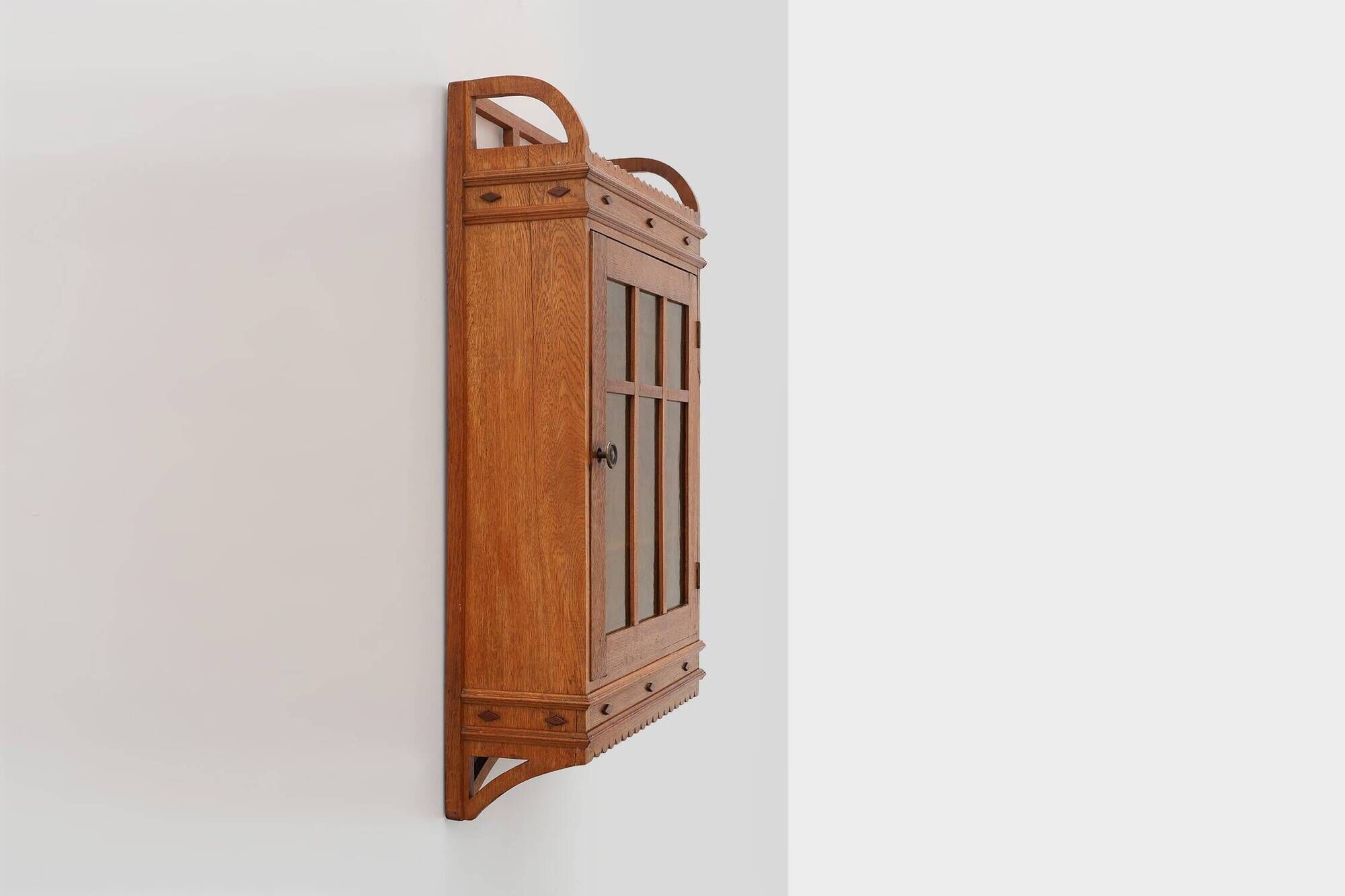 Art Deco oak wall cabinet with amber glazed door, Belgium ca. 1925