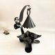 Handcrafted black wrought iron candle holder with its vintage extinguisher