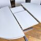 Extendable round table in white formica and 4 matching chairs by Roche Bobois.