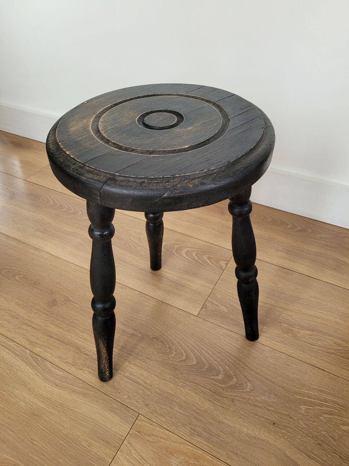 Black wooden tripod stool