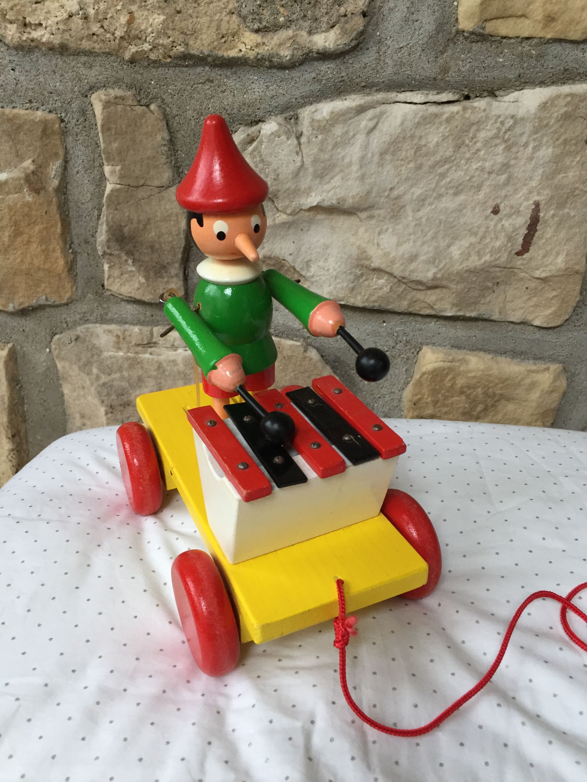 Old toy to pull Pinocchio and his xylophone