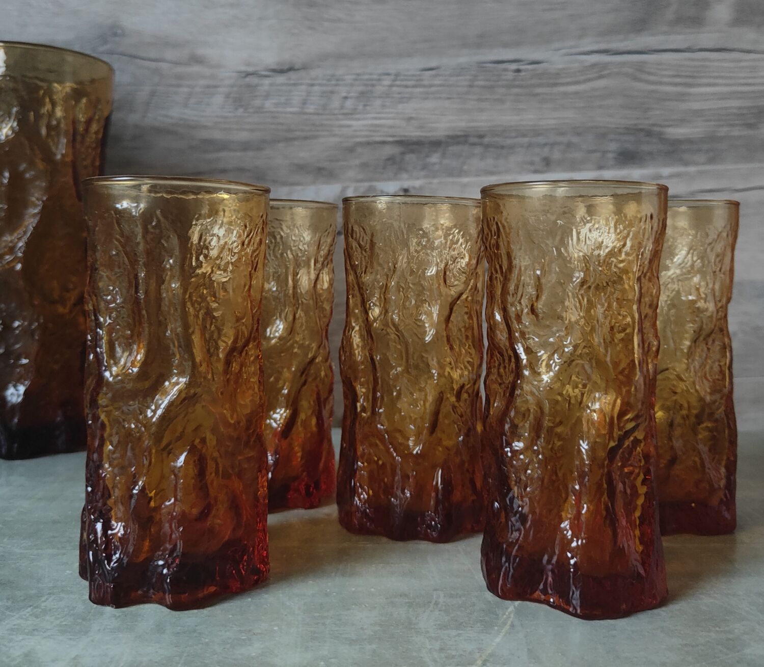 Pitcher and its glasses in amber glass