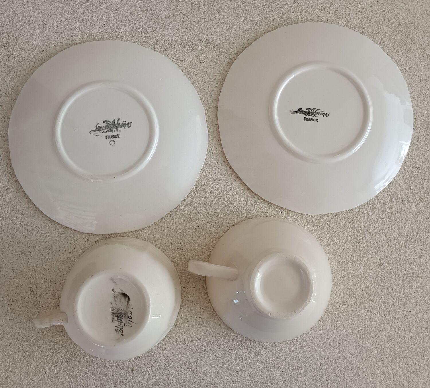 Two ivory cups and saucers from Sarreguemines