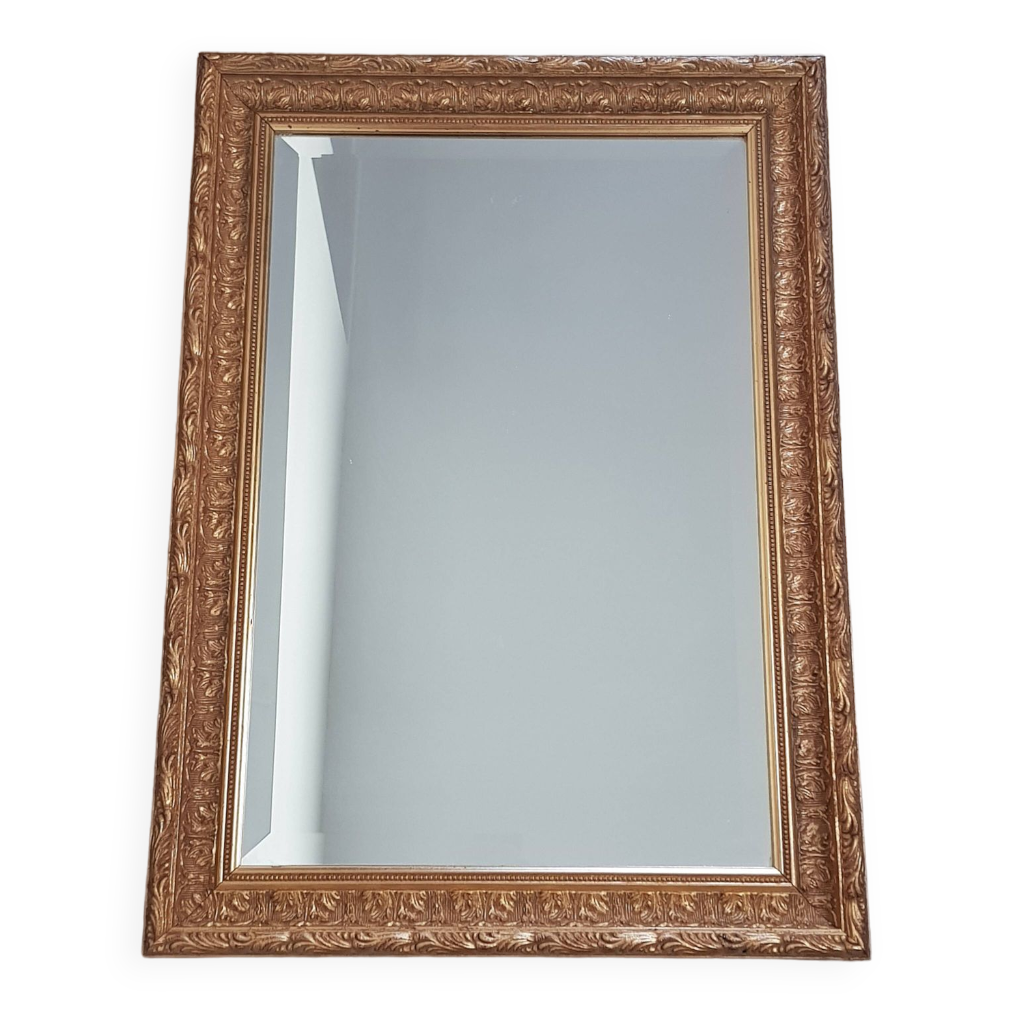 Mirror in gilded stucco wood and beveled glass