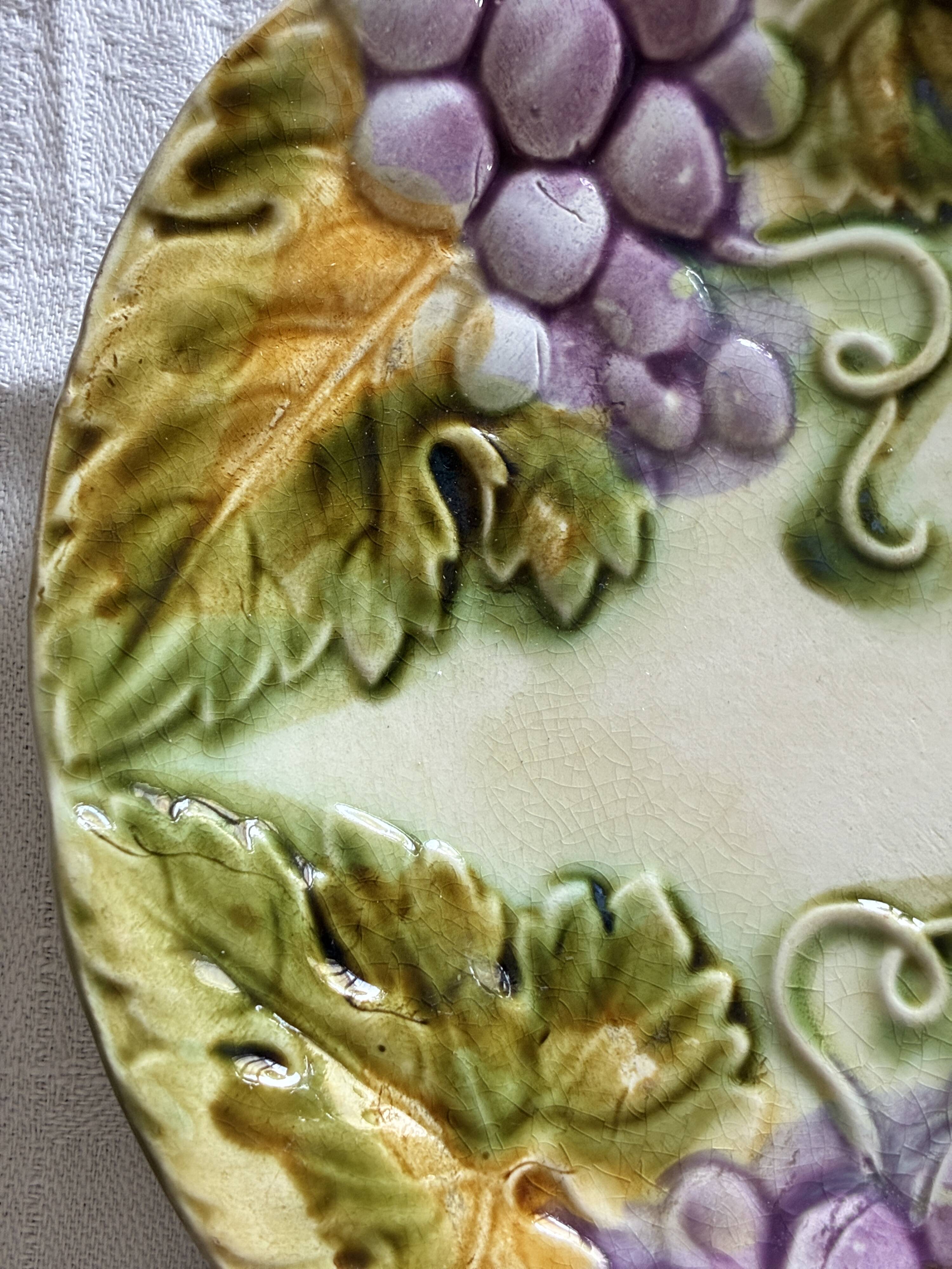 Lot of 4 Onnaing barbotine plates with grapevine design.
