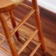 Antique wooden bar stool with a straw seat