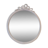 Round mirror in carved wood with at the top a ribbon forming a knot in cream color